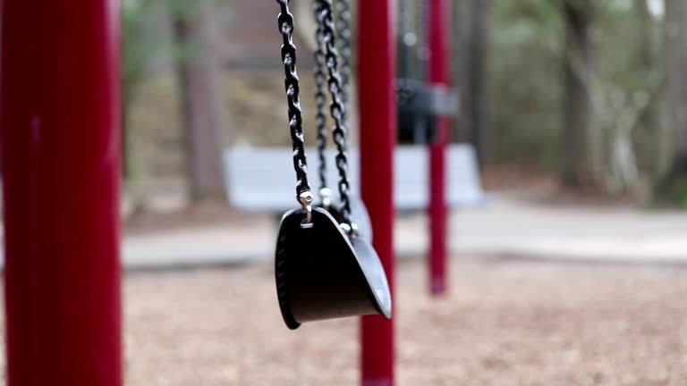 Swinging swings on empty school or park playground.