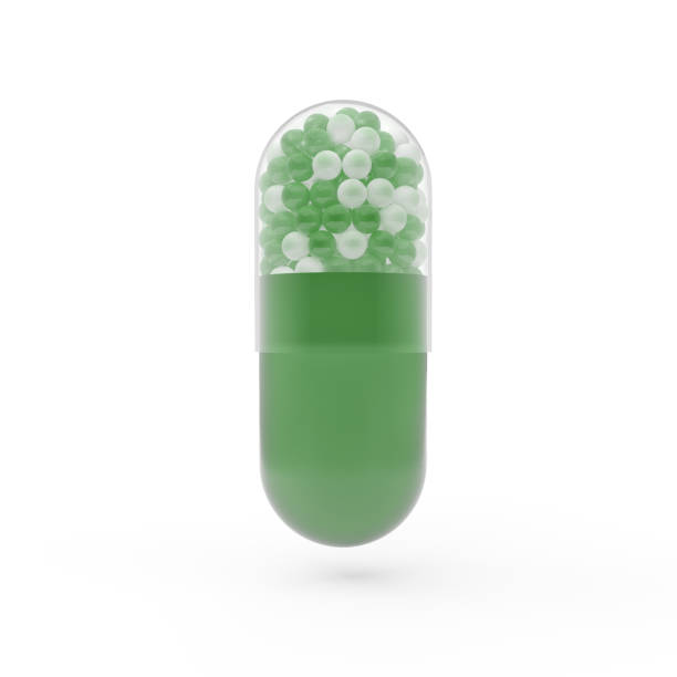 istock Green capsule tablet with green and white fractions inside. 3D render of a pill. 1144409578