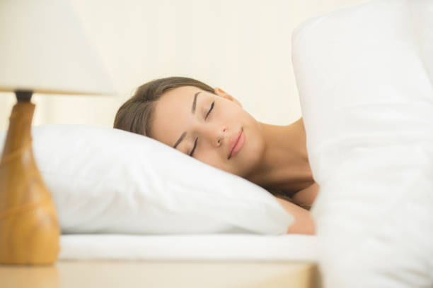 istock The beautiful woman sleeping on the bed with white linens 1144410261