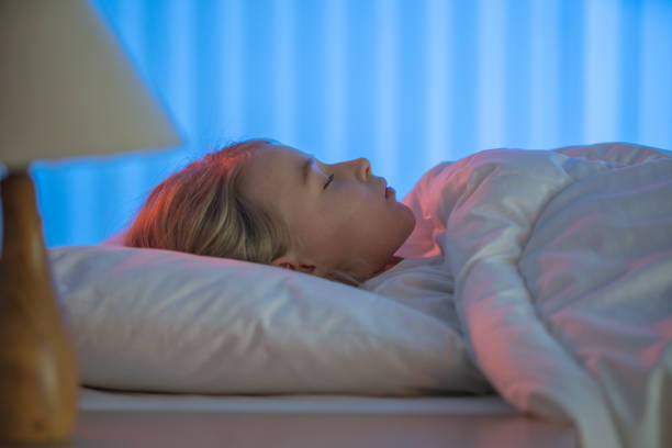 istock The beautiful girl sleeping on the bed. Evening night time 1144410615