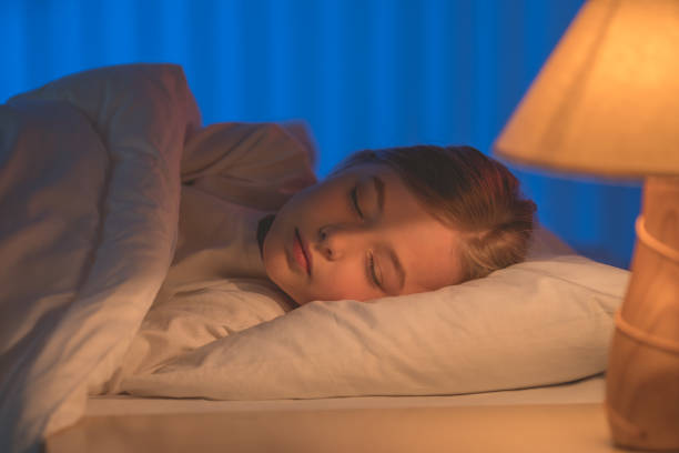 istock The cute girl sleeping on the bed. Evening night time 1144410685
