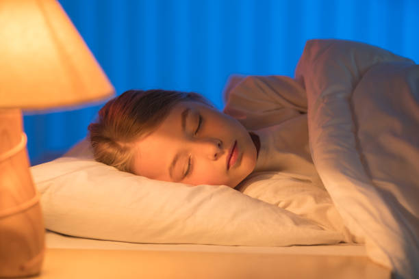 istock The pretty girl sleeping on the bed. Evening night time 1144410701