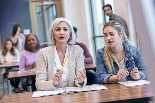 istock Caucasian grandmother asks question during granddaughters orientation 1144410723