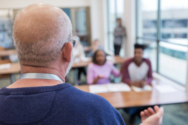 istock Male teacher talks with students and parents 1144410727