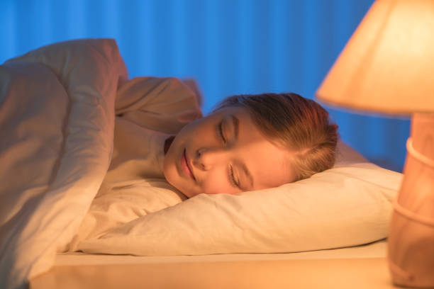 istock The cute girl sleeping on the bed. Evening night time 1144410743