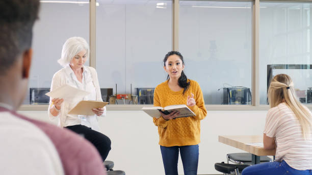 istock Confident teenage girl reads from science textbook 1144410788
