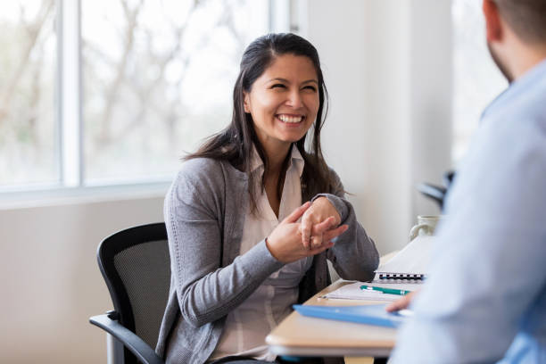 istock Sales rep talks toHispanic office manager 1144410897