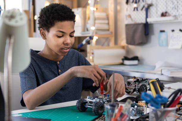 istock Teenager assembles robotic vehicle 1144411761