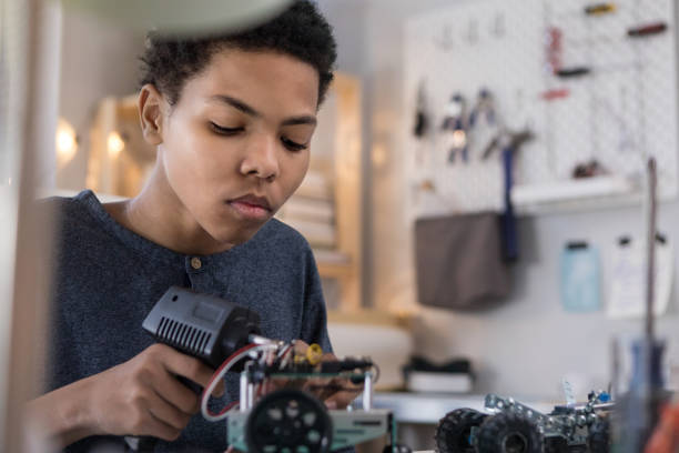 istock African American boy concentrates while building robot 1144411763