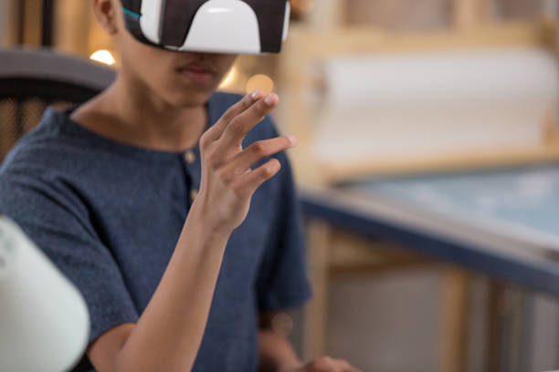 istock Teenage boy uses virtual reality glasses 1144411797