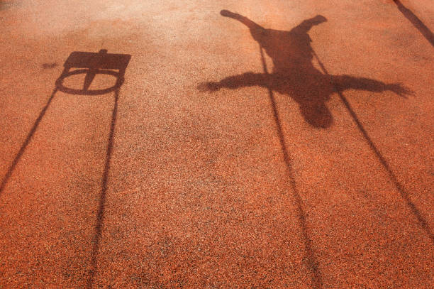 istock shadow of a childs swing 1144412241