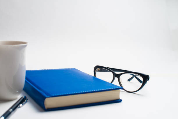 istock Notebook with glasses and pen, Book with glasses, Blue notebook with glasses, Book with cup of tea 1144414146