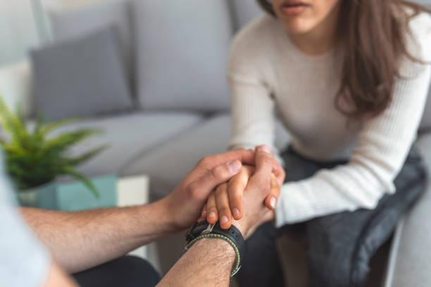 Male hands holding female Male hands holding female, caring loving understanding man showing comfort and empathy, giving psychological support to woman in marriage relationships concept, couple reconciliation, close up view woman comforting depressed friend stock pictures, royalty-free photos & images