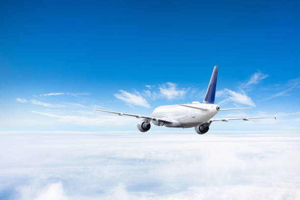 istock Airplane flies above the clouds high in the sky. 1144415633