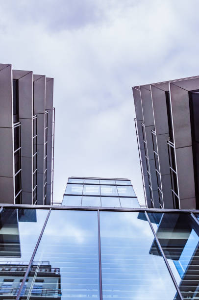 istock Fragment of a modern building with cloudy sky on the background 1144416639