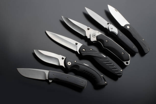 istock folding knives on a black background. pen knives on a dark background 1144416758