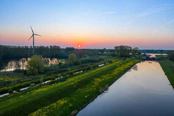 Wind turbine at sunset Wind turbine generating green energy during sunset as seen from above in Waalwijk, Noord Brabant, Netherlands berkel stock pictures, royalty-free photos & images