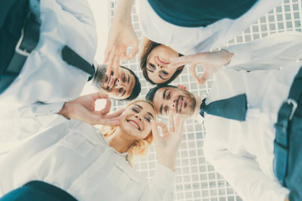 istock The four happy people gesture to the camera 1144417985