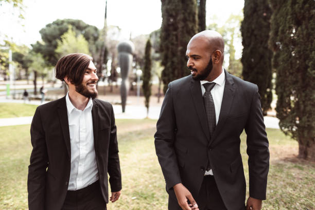 istock business man talking together in the park 1144419135