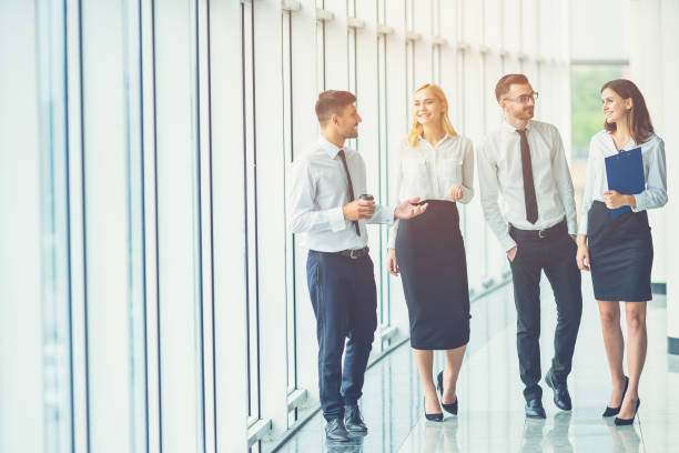 istock The business people walk in the office hall 1144419306