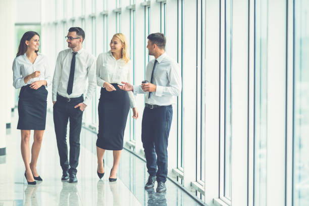 istock The business people walk in the office hall 1144419337