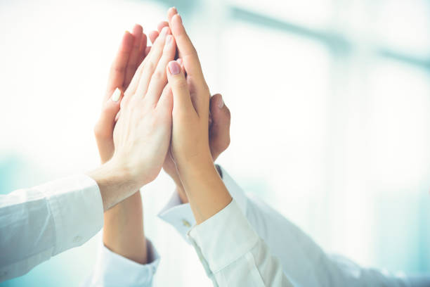 istock The four hands greeting with a high five 1144419339