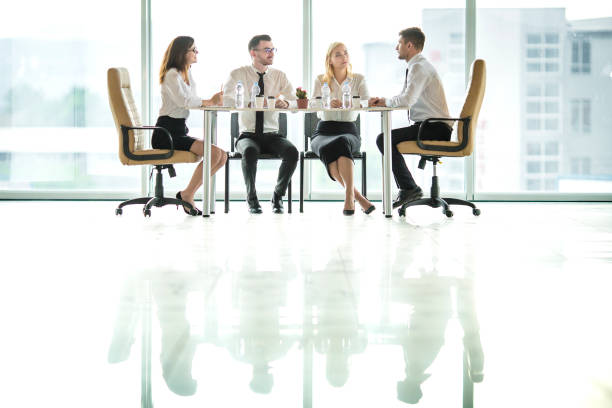 istock The four business people sit at the table and discuss 1144419682