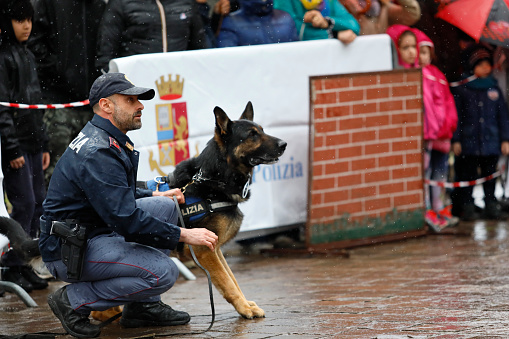 Rome, Italy - April 14, 2019: Piazza San Giovanni Bosco, a policeman from the canine department and his dog, during a practical exercise in front of the public in the square.