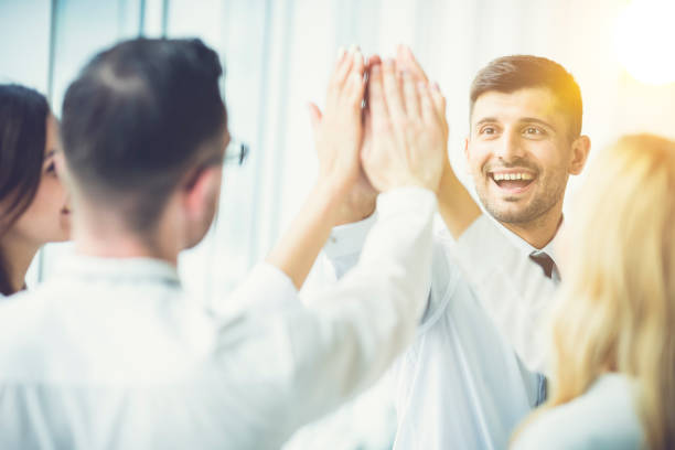 istock The happy people greeting with a high five on the sun background 1144420421