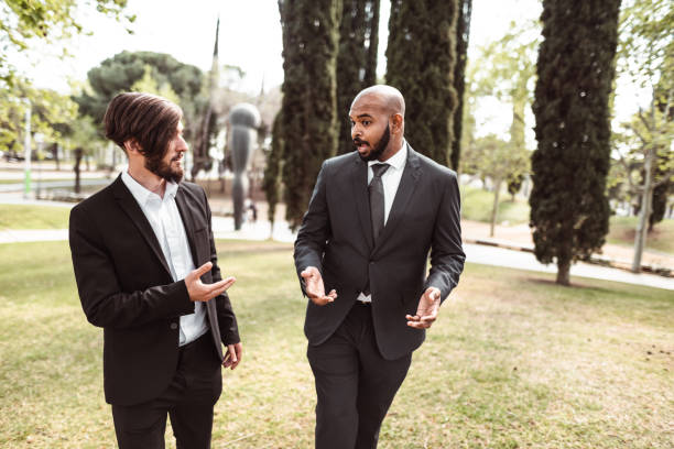 istock business man talking together in the park 1144420516