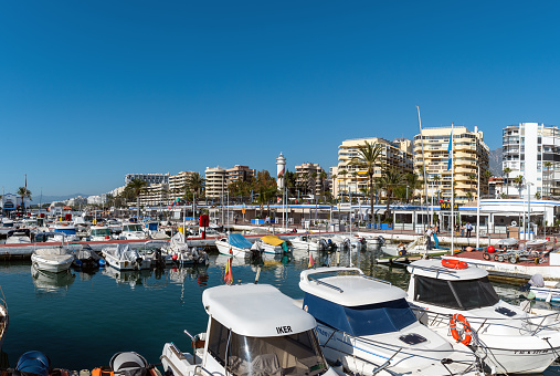 Marbella, Spain - December 2018: Small port full of moored motorboats and yachts near the centre of city.