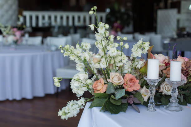 istock Event white restaurant table served and decorated with delicate fresh flowers. 1144424947