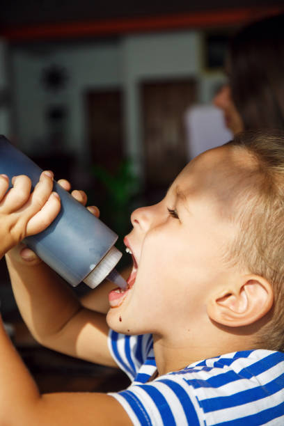 istock Little boy is drinking chocolate topping in Thailand 1144427428
