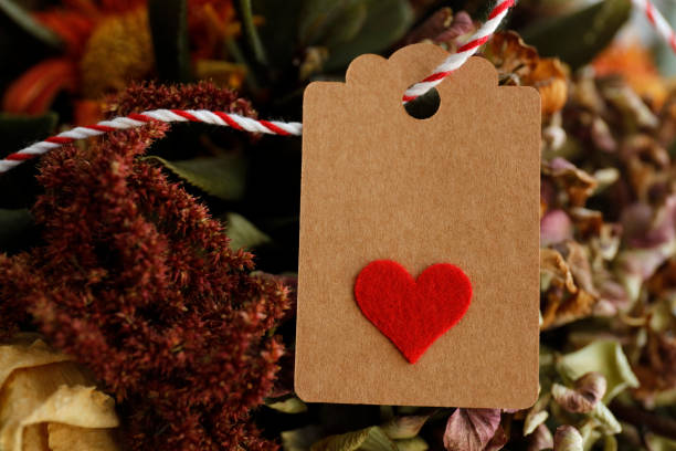 istock Cream-colored, price tag with red heart on a red cord 1144428115