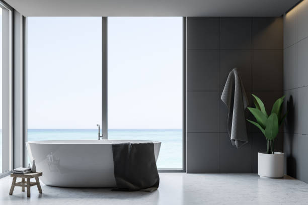 istock Gray tile bathroom interior, tub and towel 1144428305