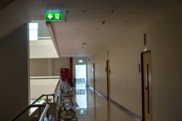 istock Green emergency exit sign showing the way to escape.Fire exit in the building. 1144428355