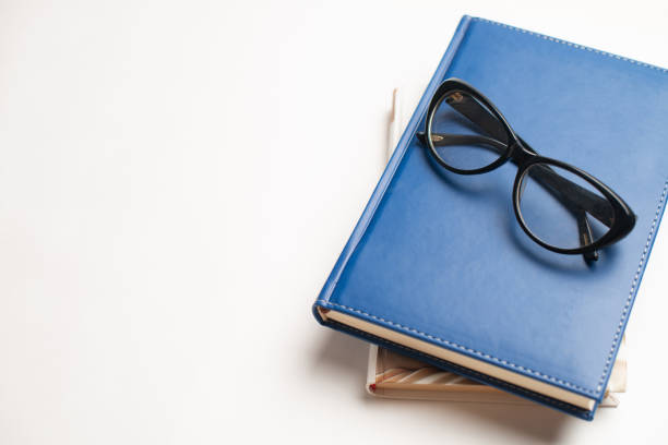 istock Notebook with glasses and pen, Book with glasses, Blue notebook with glasses, Book with cup of tea 1144428477