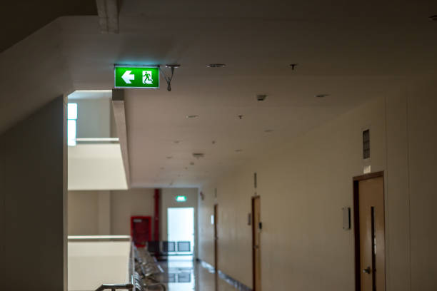istock Green emergency exit sign showing the way to escape.Fire exit in the building. 1144429250