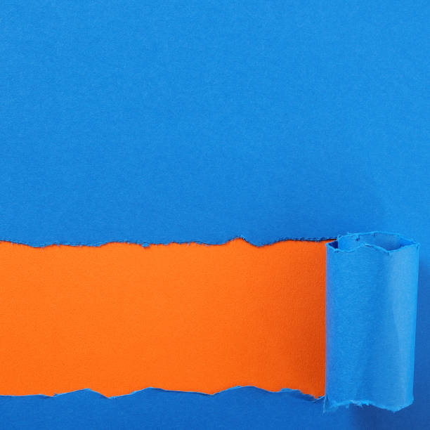 istock Torn blue paper strip orange background 1144429387