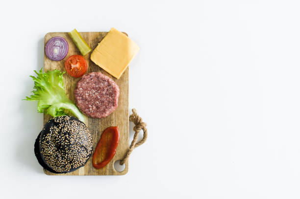 istock Ingredients for the black Burger on wooden cutting Board. 1144430517