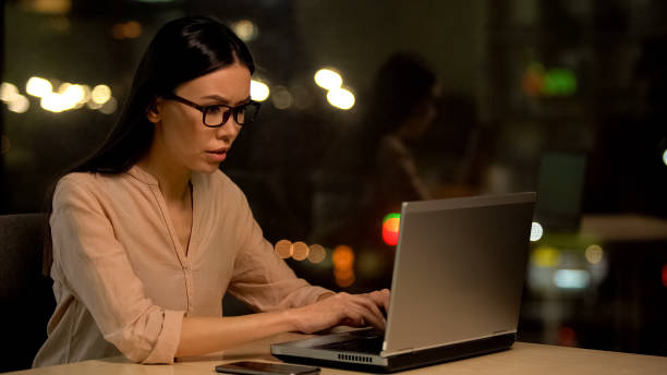 istock Concentrated female in eyeglasses working laptop, preparing report, project 1144431469