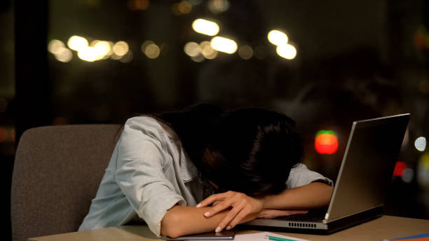 istock Tired young lady sleeping on table, feeling bored in office, work exhaustion 1144431494