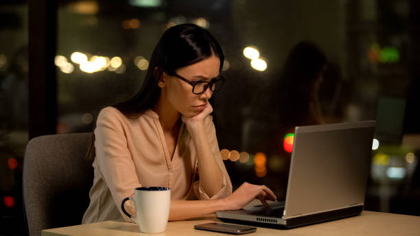 istock Upset woman typing on laptop working at night, project deadline, tasks overload 1144431630
