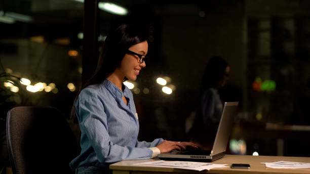istock Happy freelancer working laptop at night, flexible schedule, productive employee 1144431668