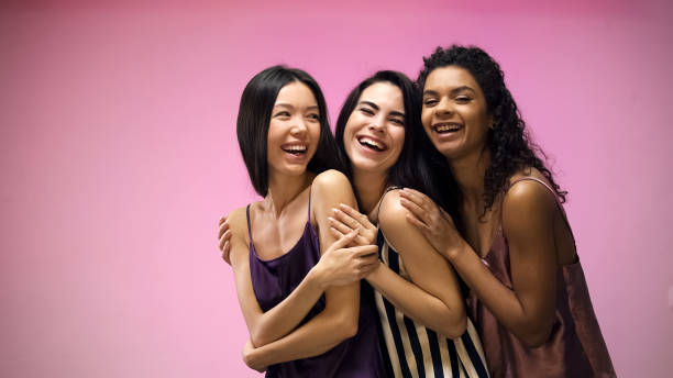istock Multiracial women in pajamas hugging and posing for camera, having fun together 1144431678