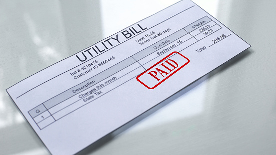 Utility bill paid, seal stamped on document, payment for services, charges