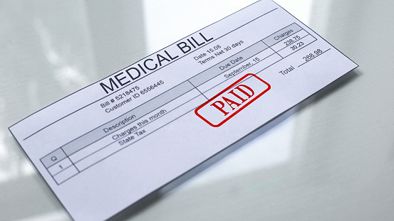 Medical bill paid, seal stamped on document, payment for services, tariff