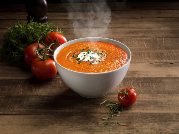 Tomato Soup Tomato Soup with cheese and fresh mint leaves. tomato soup stock pictures, royalty-free photos & images