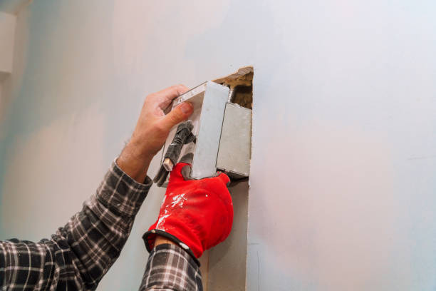 istock Electrician at work cutting wall for cabling different electric cables looking wall 1144434922