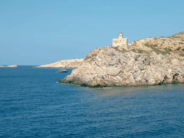 istock sailing past the lighthouse in ormos harbor on the island of ios 1144438947